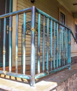 Rusty metal railing on a porch with chipped paint.