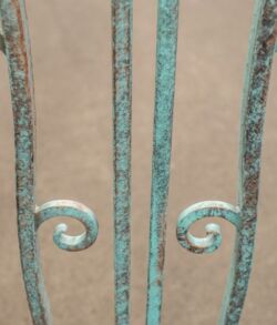 Close-up of rusted decorative metal bars with spiral designs.
