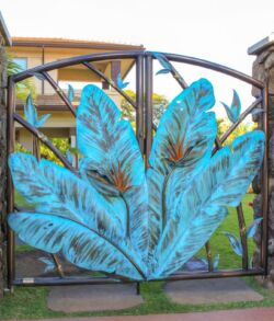 Decorative metal gate featuring large blue leaves with intricate details.