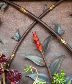 Decorative wall art featuring crossed swords and colorful flowers.
