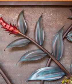 Decorative metal artwork featuring a branch with leaves and red berries.