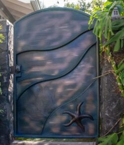 Decorative metal gate with artistic wave and star designs.