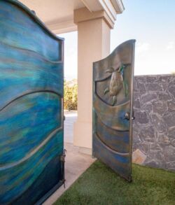 Decorative blue and gray doors with artistic designs, partially open.