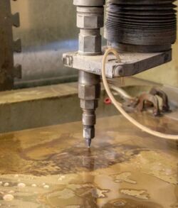 A waterjet cutter slicing through material with precision.