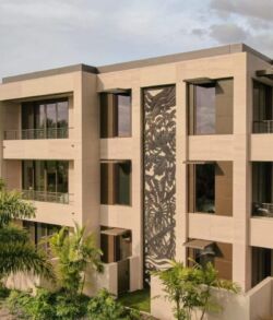Modern multi-story building with large windows and beige exterior.