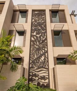 Modern building facade featuring a decorative vertical metal panel.
