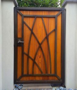 Brass and Teak wood Wooden door with black geometric frame and orange panels.