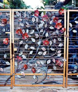 Brass with copper Hibiscus flowers Decorative metal gate with artistic floral design and red accents.