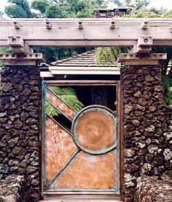 All Copper man gate Rustic stone pillar entrance with wooden beam and metal gate.