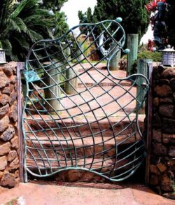 Copper woven fishnet man gate Artistic metal gate with a flowing, wave-like design.