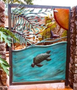 Decorative metal gate featuring a turtle and tropical leaves design.