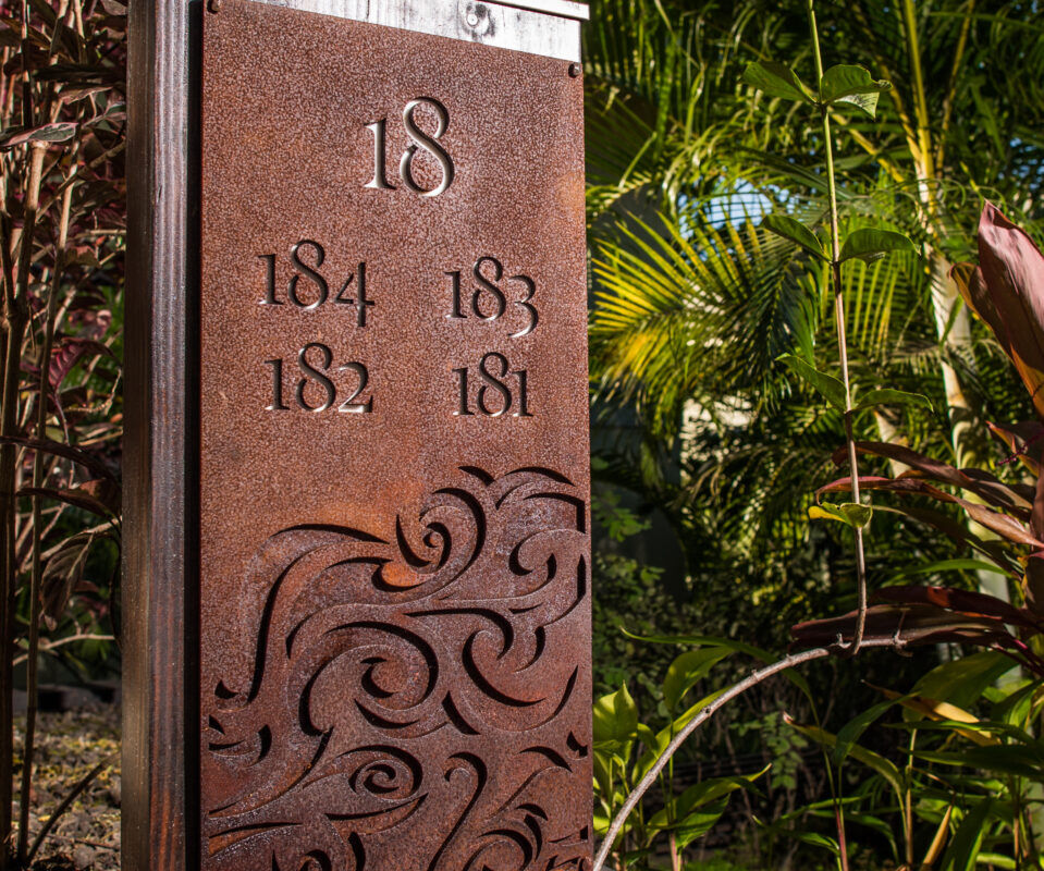Decorative rust-colored metal panel with numbers and intricate patterns.