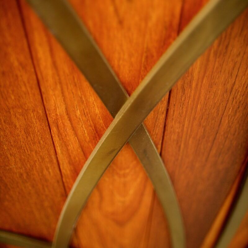 Close-up of intertwined wooden curves with metal bands.