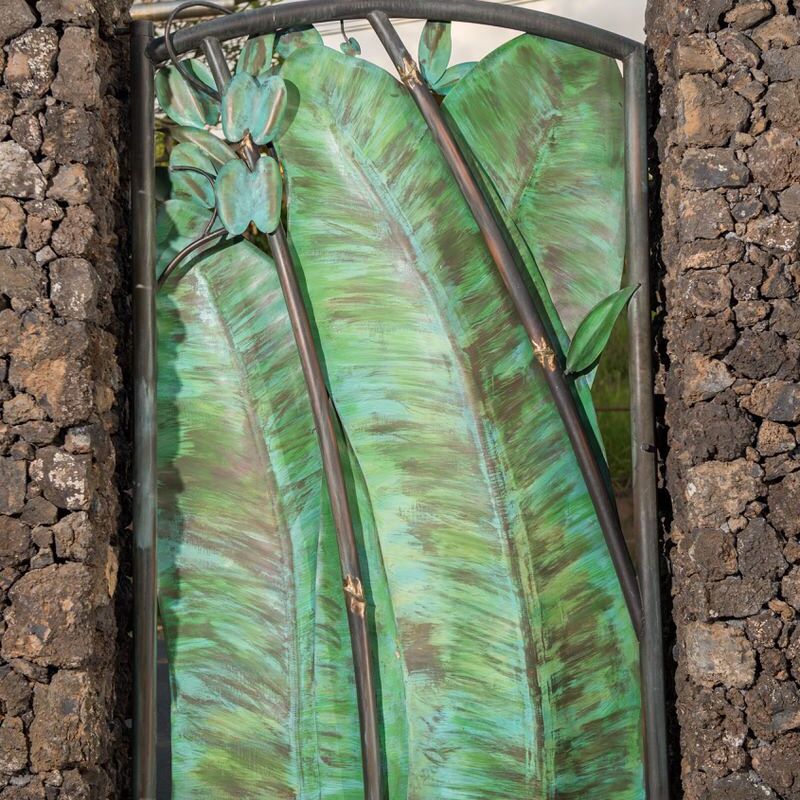 A decorative stained glass door with green banana leaf design.