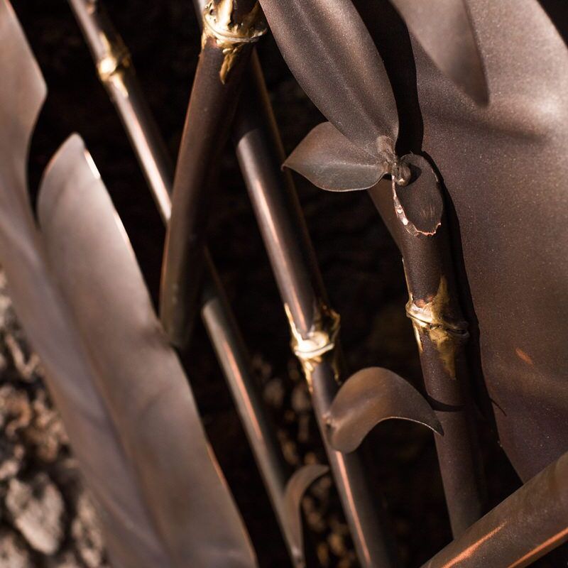 Close-up of brass and wooden parts of a musical instrument, possibly a clarinet.