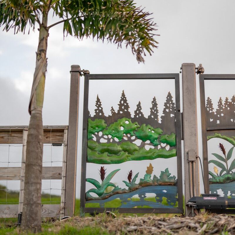 Decorative outdoor wall panels featuring nature-themed paintings with trees and flowers.