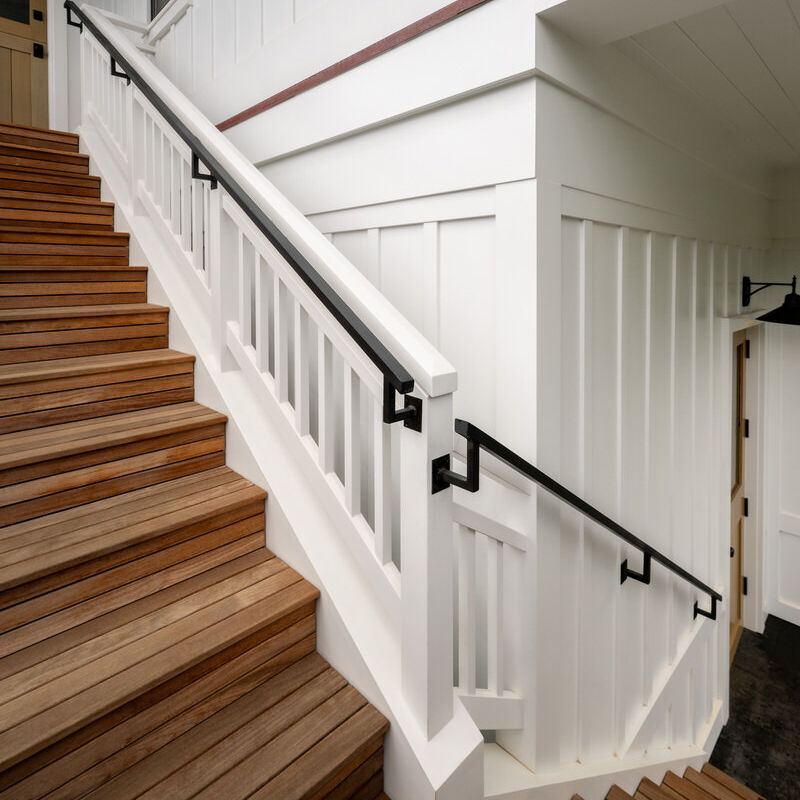 Ascending wooden stairs with white railing