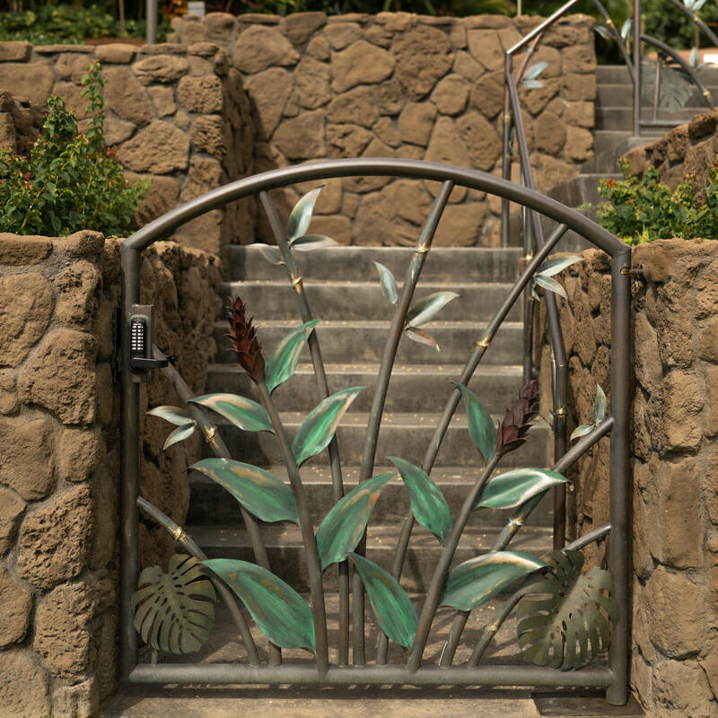 Decorative metal garden gate with green leaves