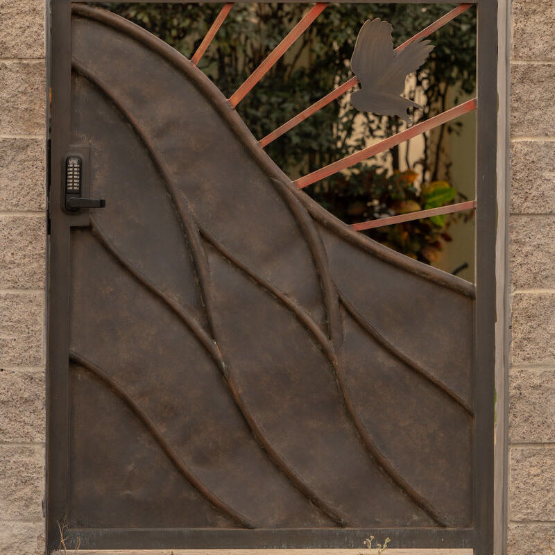 Bronze gate panel with sinuous wave design